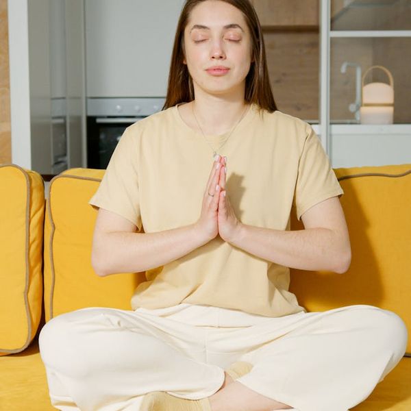 Person resting hands over eyes for deep relaxation practice.